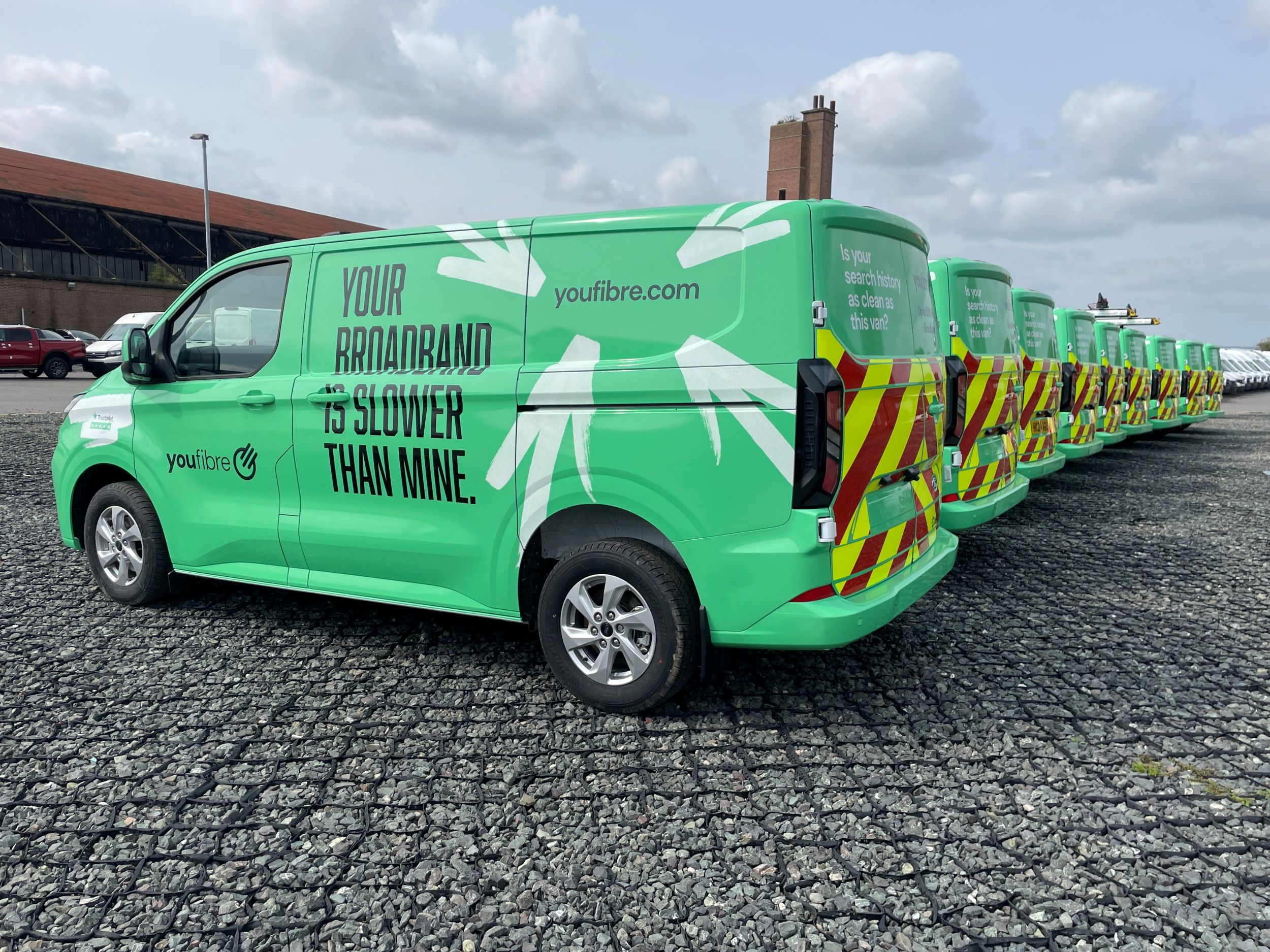 Fully wrapped Youfibre fleet vehicles lined up in a row